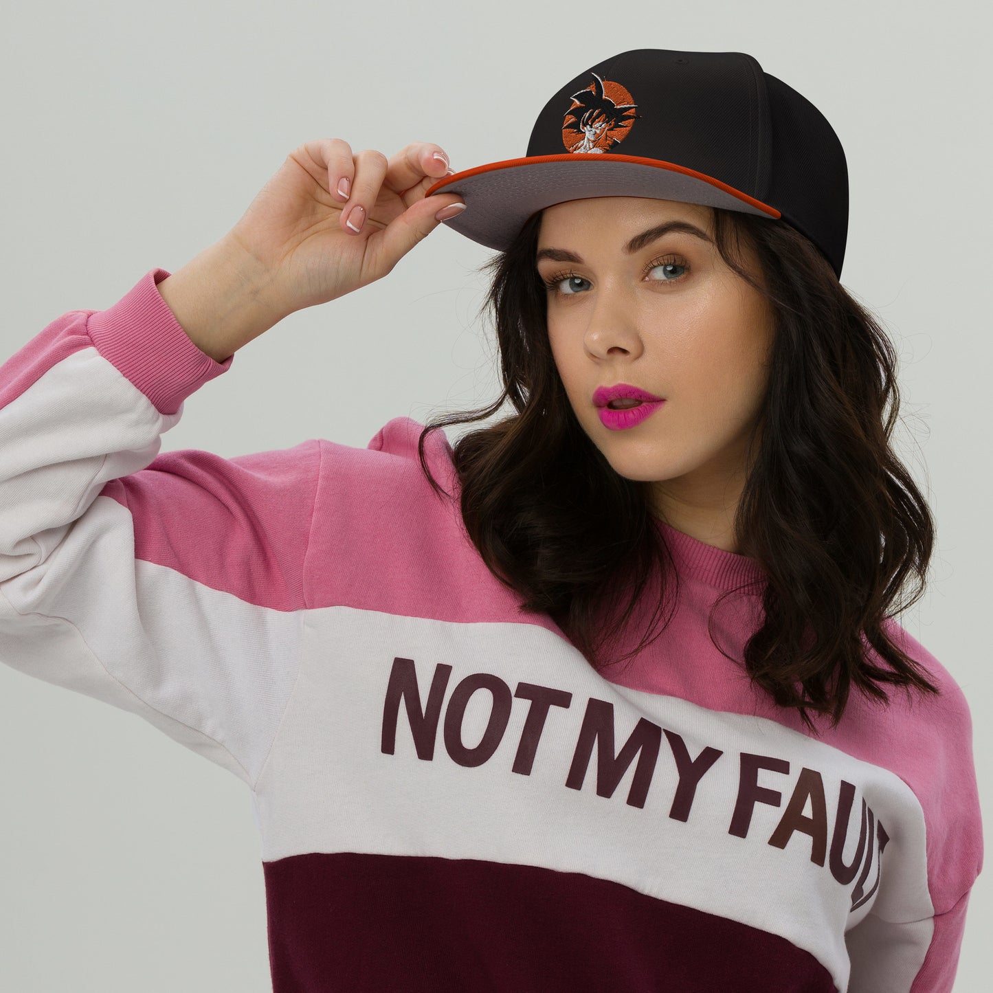  Lifestyle image of someone wearing the Goku Snapback Hat in an urban setting, highlighting its comfort and style for everyday wear. Female Model 