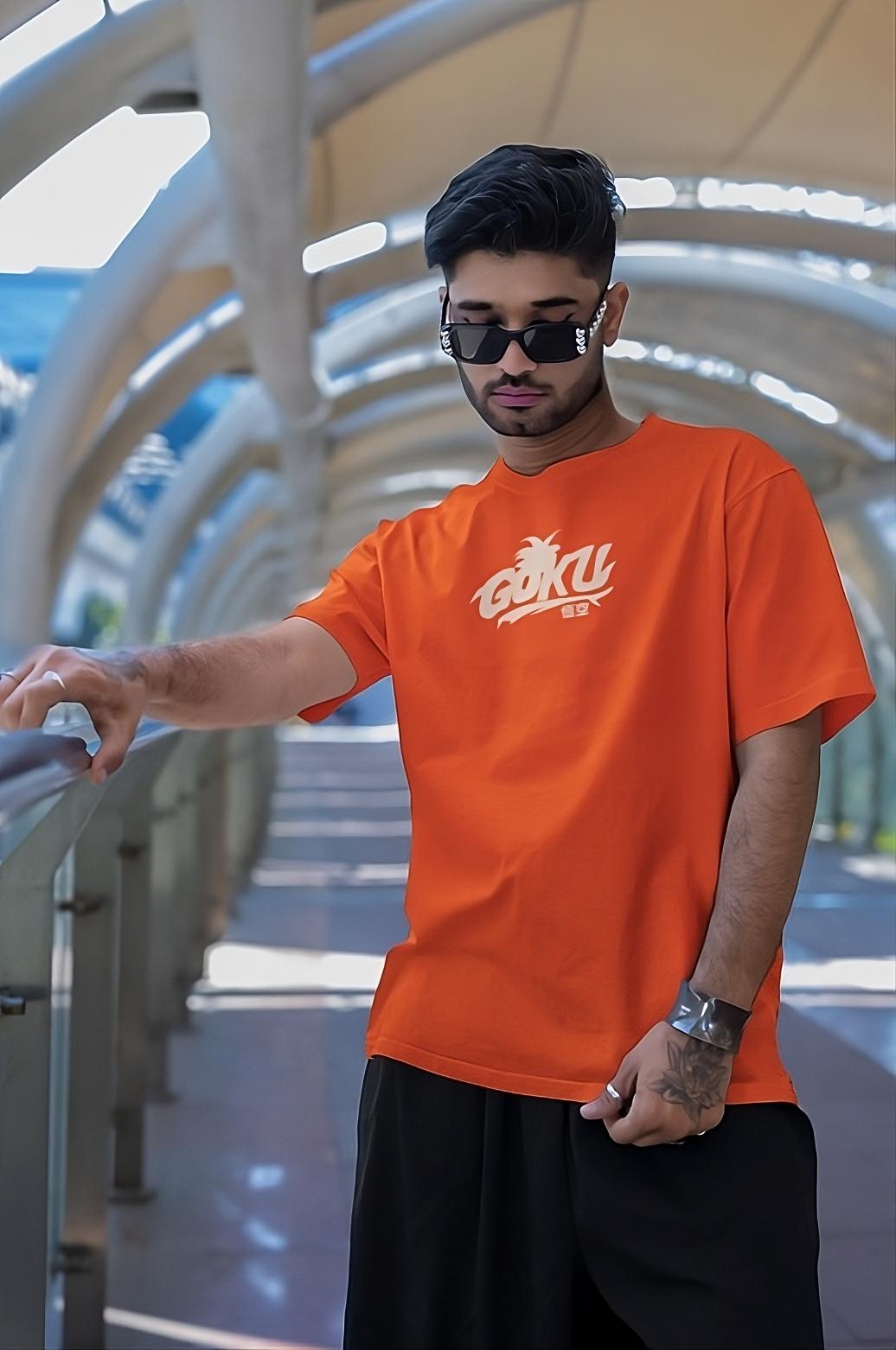 Model wearing the Goku Themed Orange T-Shirt in an outdoor setting, exuding confidence and anime fandom style.